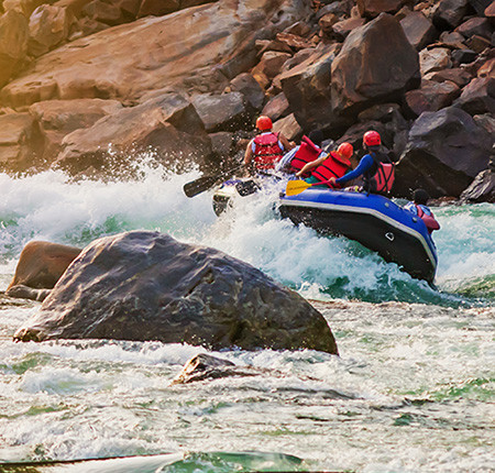 Group of travellers white water rafting